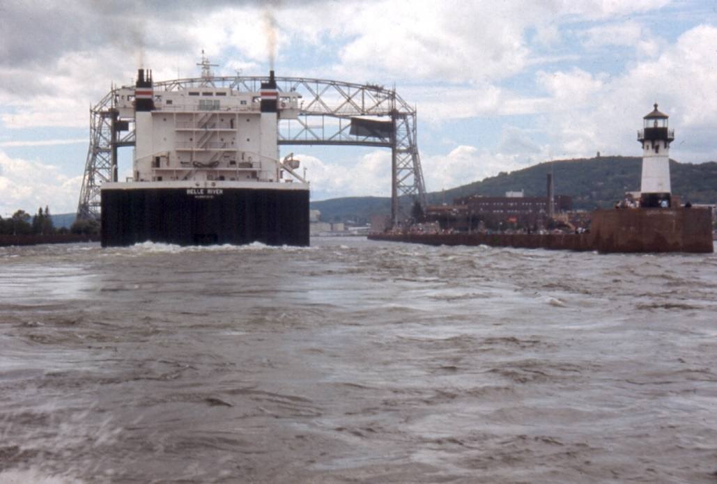Ore Boat (1000') passing under the Aerial Lift Bridge, entering Duluth Harbor.