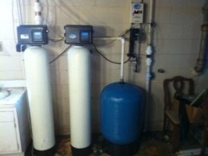 Residential filtration tanks and a pressure tank in a basement